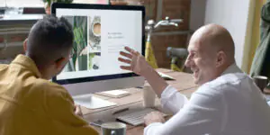 photo-of-people-sitting-in-front-of-computer-3184613-min