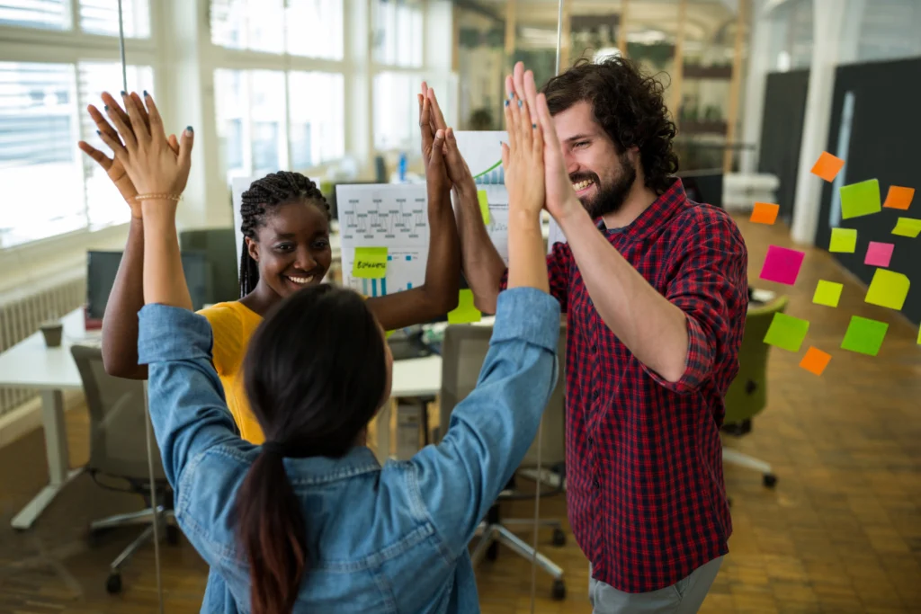 group graphic designers giving high five each other group graphic designers giving high five each other