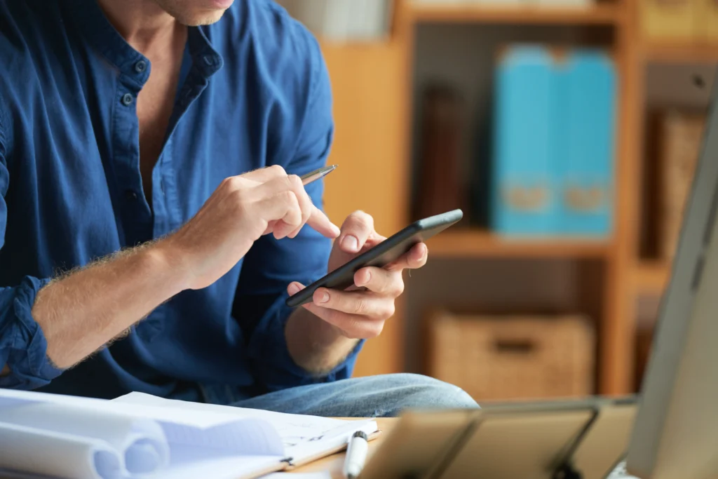casually dressed unrecognizable man using smartphone work office casually dressed unrecognizable man using smartphone work office