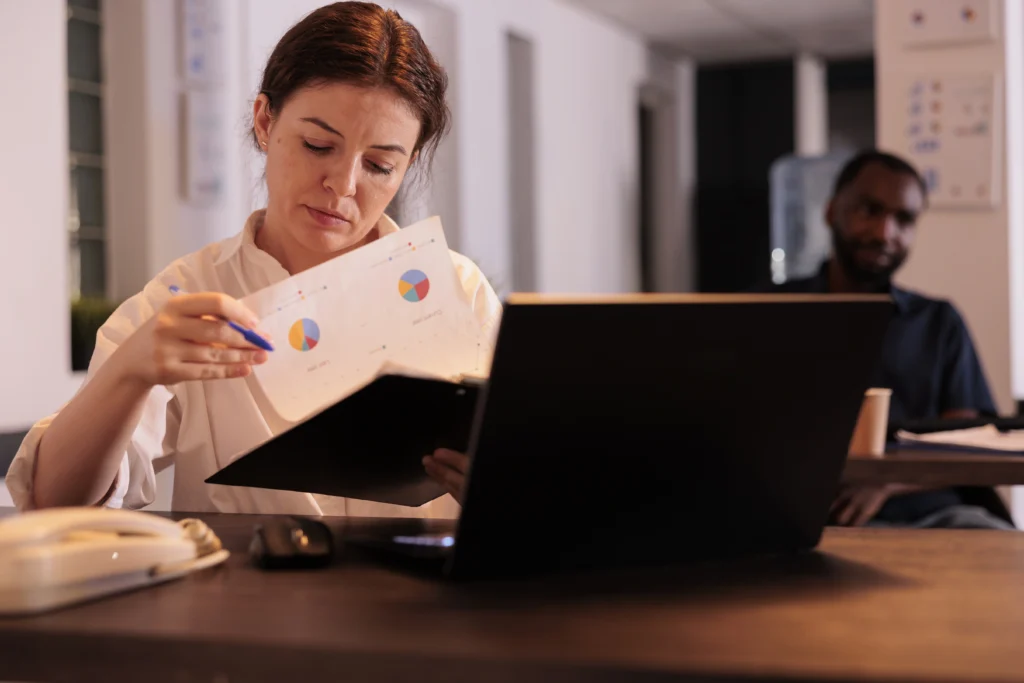 financial analyst reading company report analyzing statistics data project manager planning startup strategy employee checking research result workplace desk coworking space financial analyst reading company report analyzing statistics data project manager planning startup strategy employee checking research result workplace desk coworking space