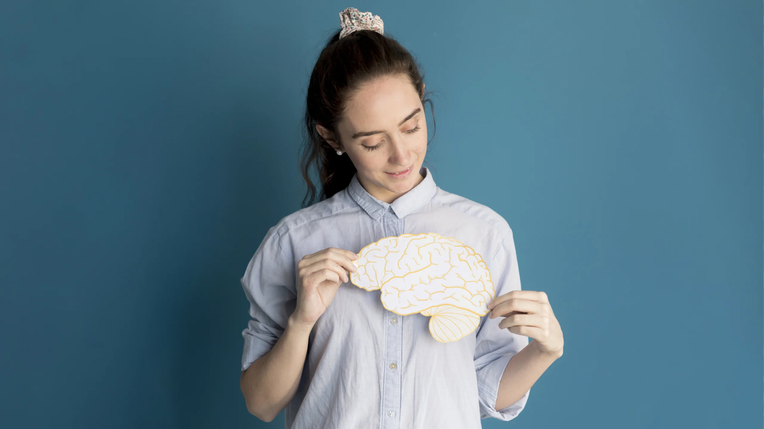 front view woman holding paper brain 1 scaled front view woman holding paper brain 1 scaled