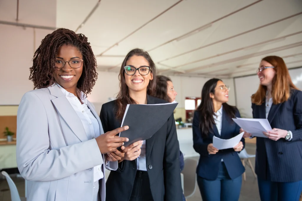 group smiling women holding paper documents group smiling women holding paper documents