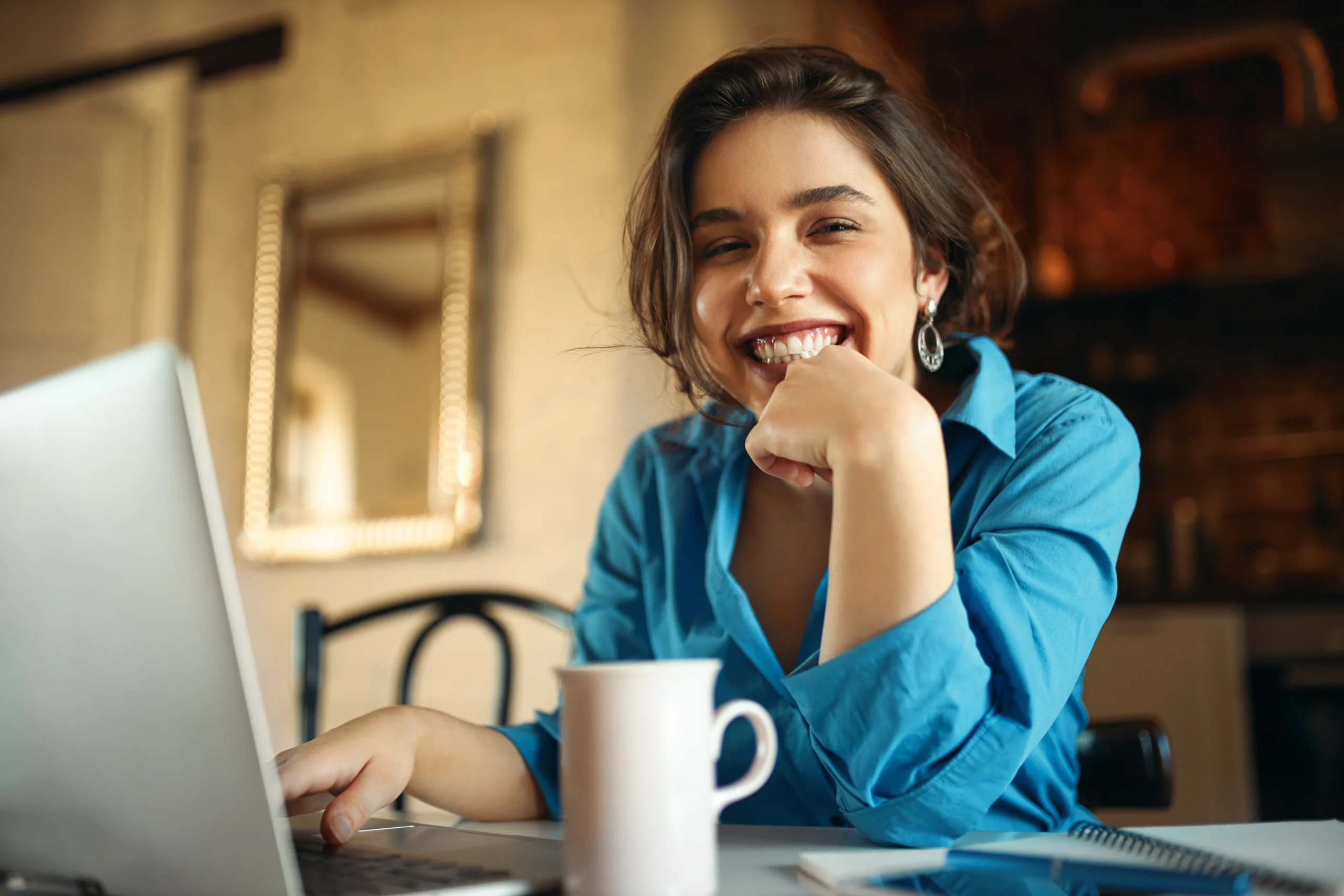 cheerful attractive young woman enjoying distant work sitting desk using portable computer drinking coffee pretty female blogger working from home uploading video her channel smiling scaled cheerful attractive young woman enjoying distant work sitting desk using portable computer drinking coffee pretty female blogger working from home uploading video her channel smiling scaled