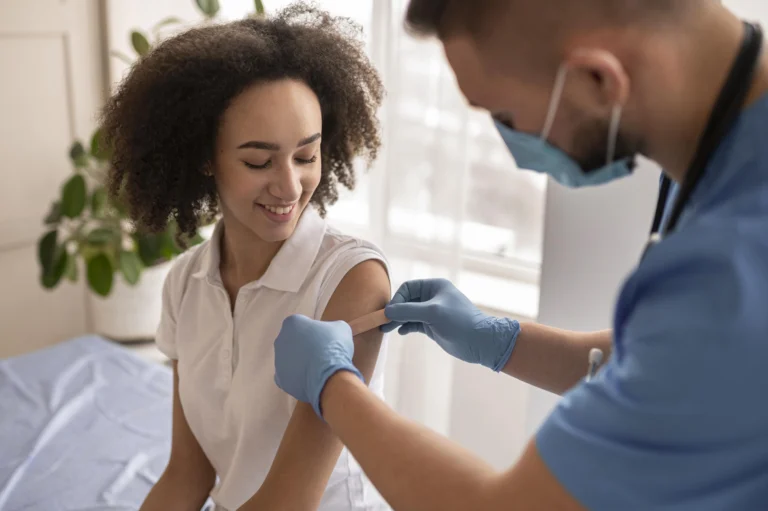 doctor putting patch patient arm after vaccination