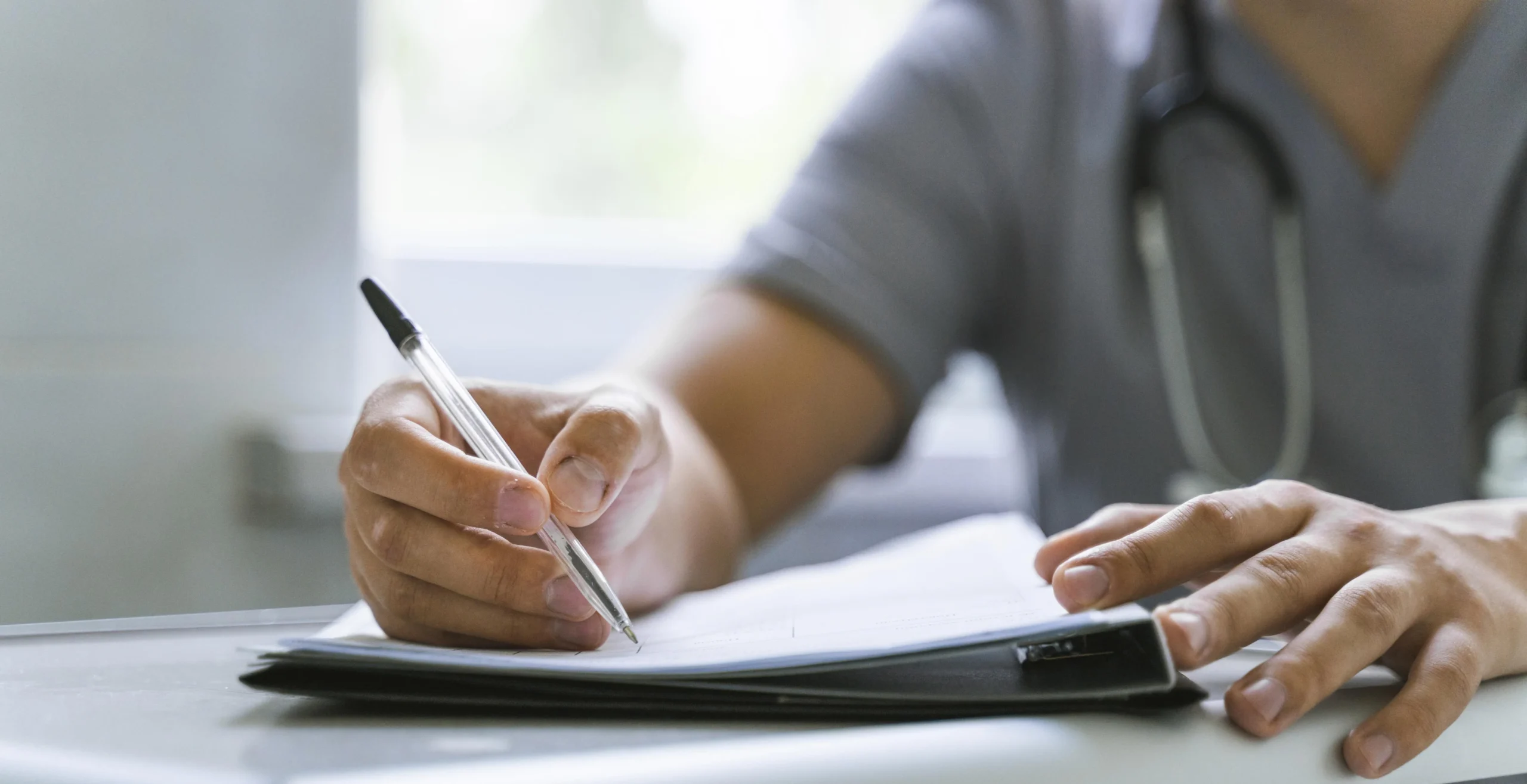 front view doctor writing prescription scaled front view doctor writing prescription scaled