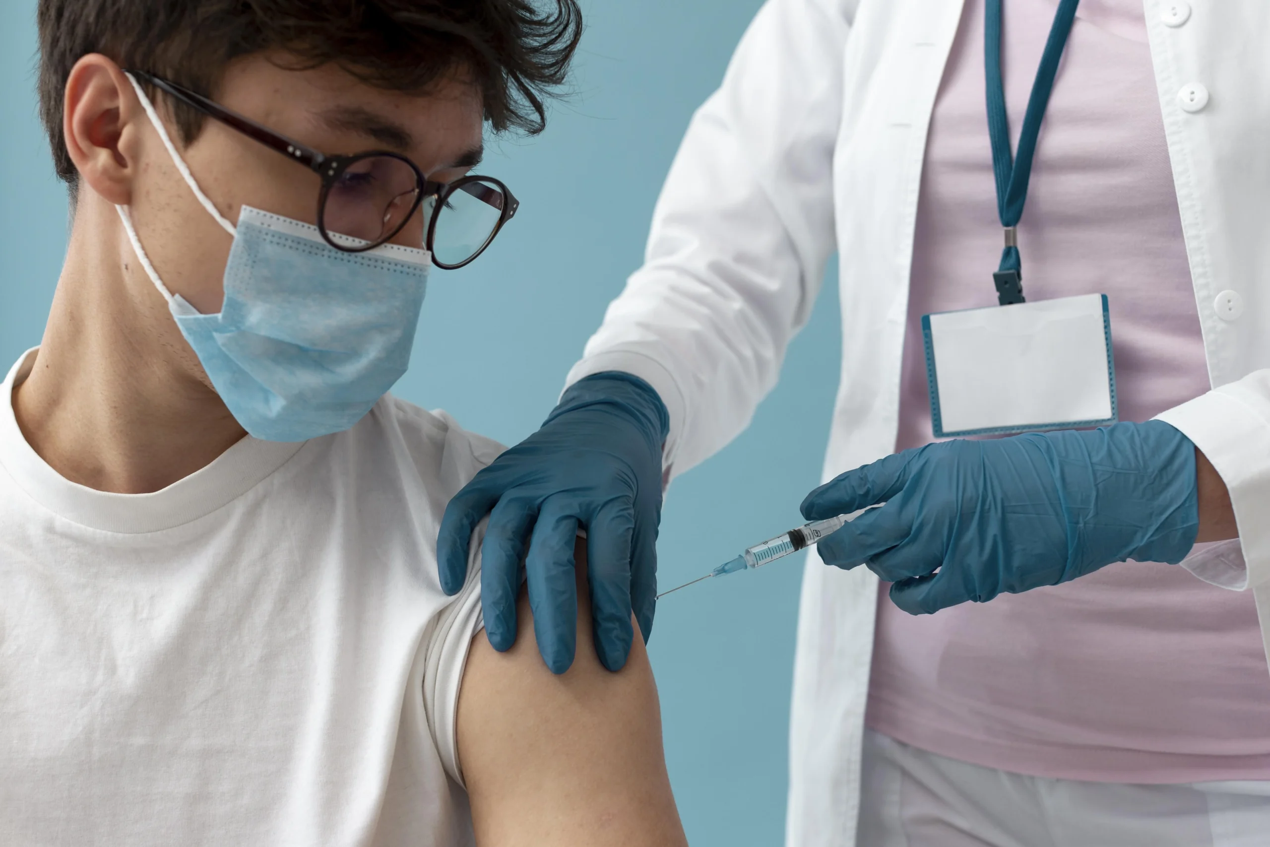 man getting vaccine close up scaled man getting vaccine close up scaled