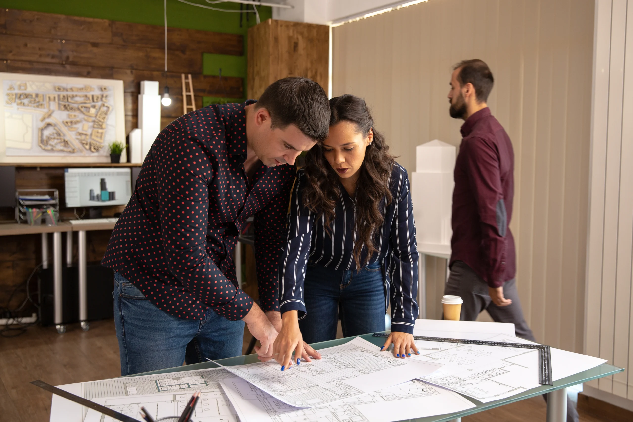 two fellow architects standing table discussing project modern office scaled two fellow architects standing table discussing project modern office scaled