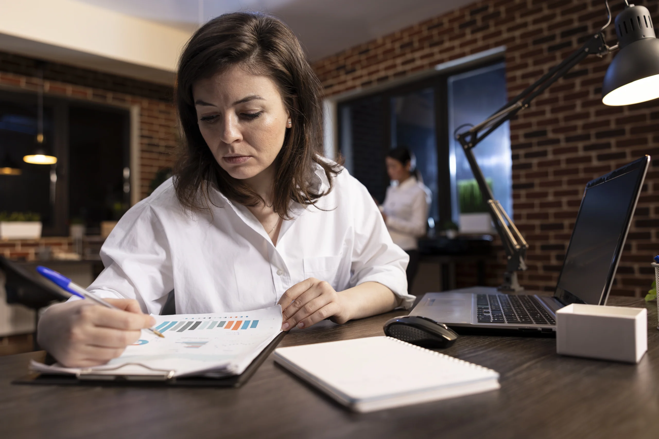 businesswoman reviewing documents scaled businesswoman reviewing documents scaled