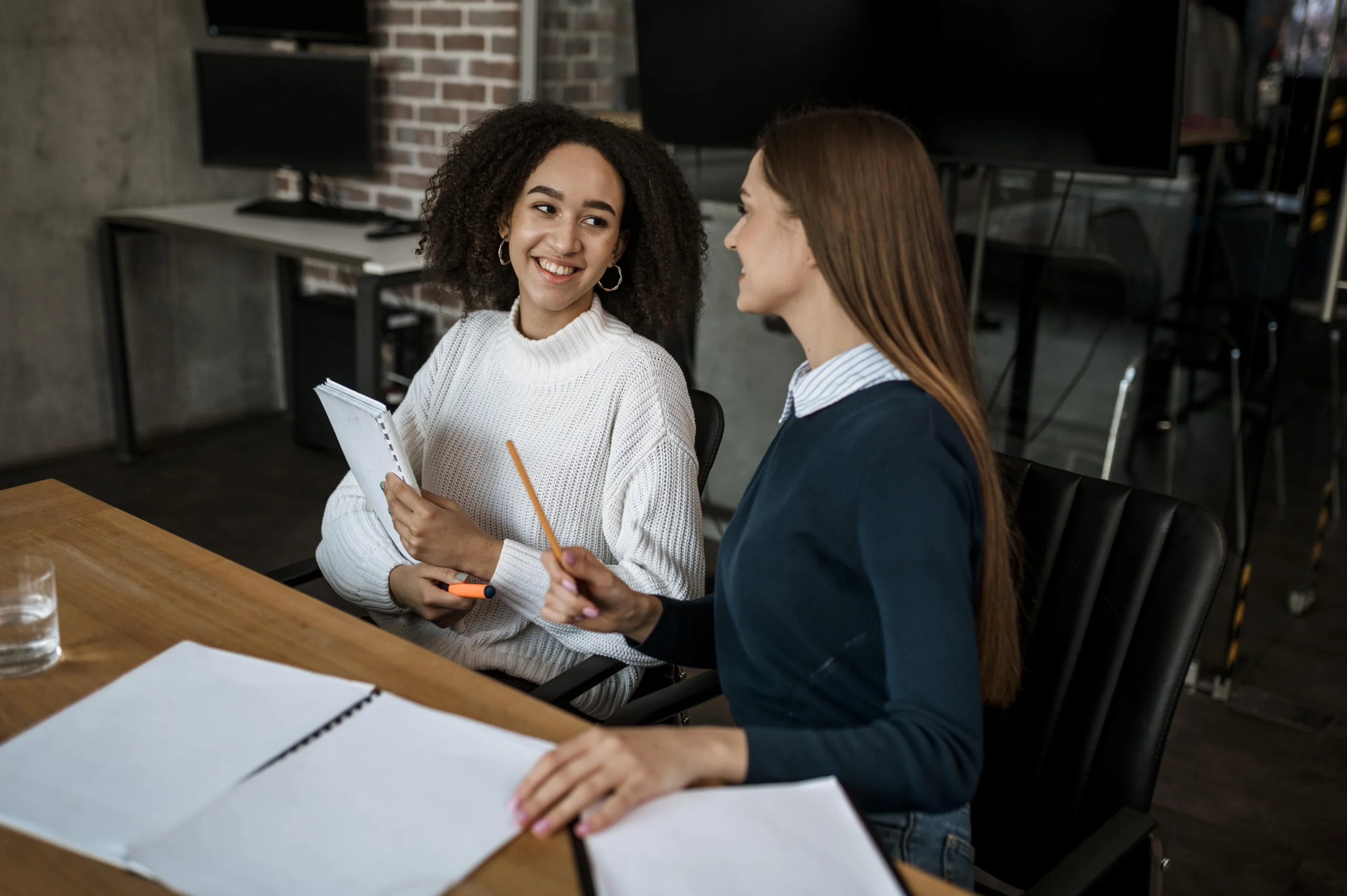 female colleagues talking each other meeting scaled female colleagues talking each other meeting scaled