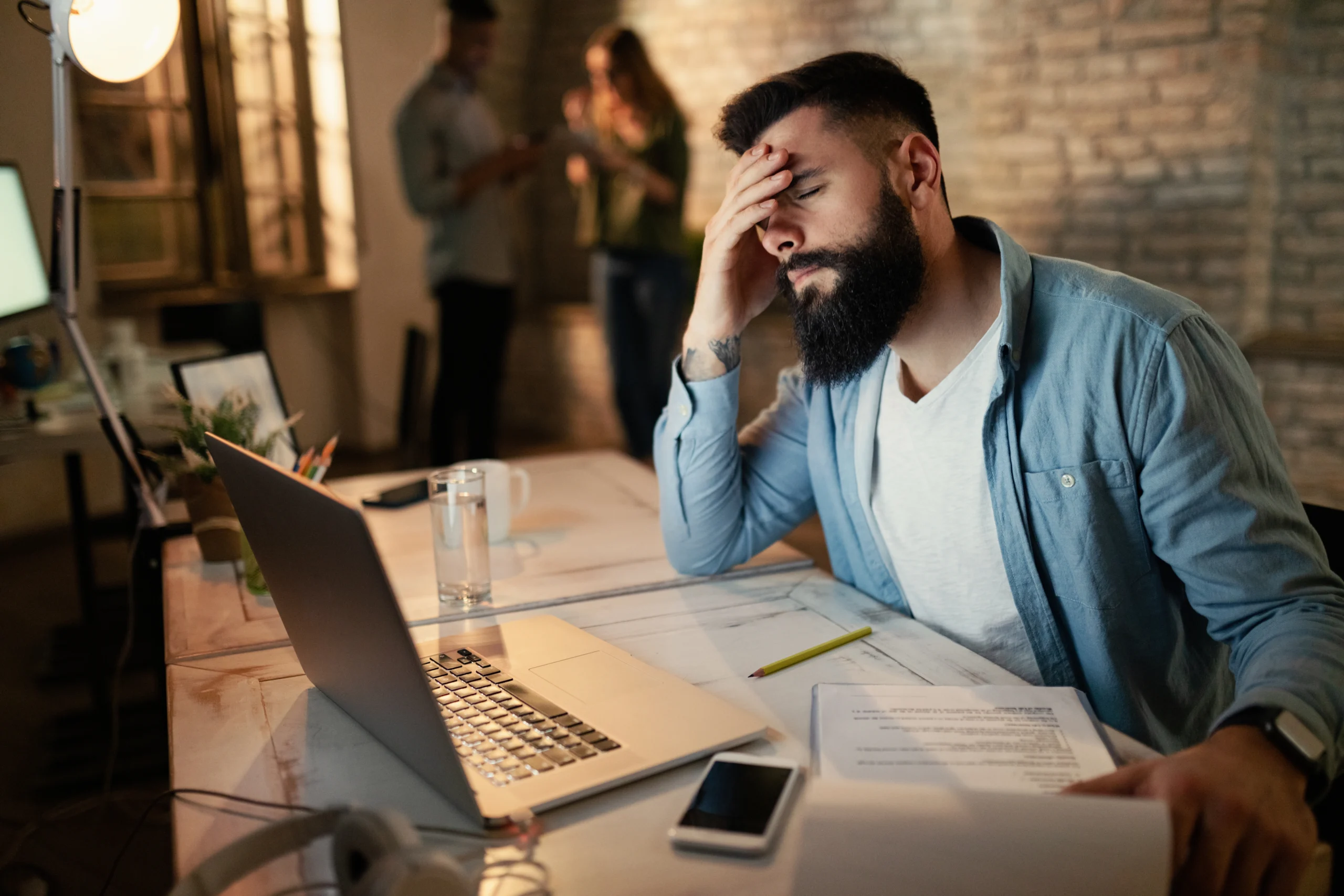exhausted businessman holding his head pain while working late office scaled exhausted businessman holding his head pain while working late office scaled