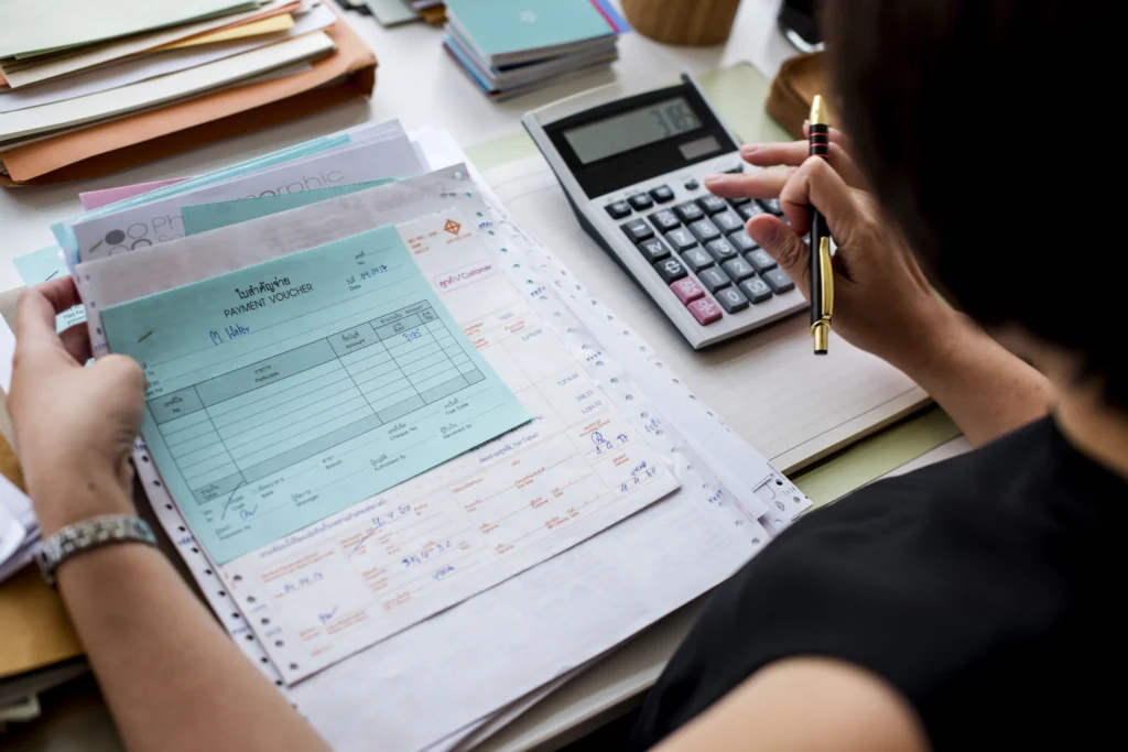 asian woman working through paperwork asian woman working through paperwork