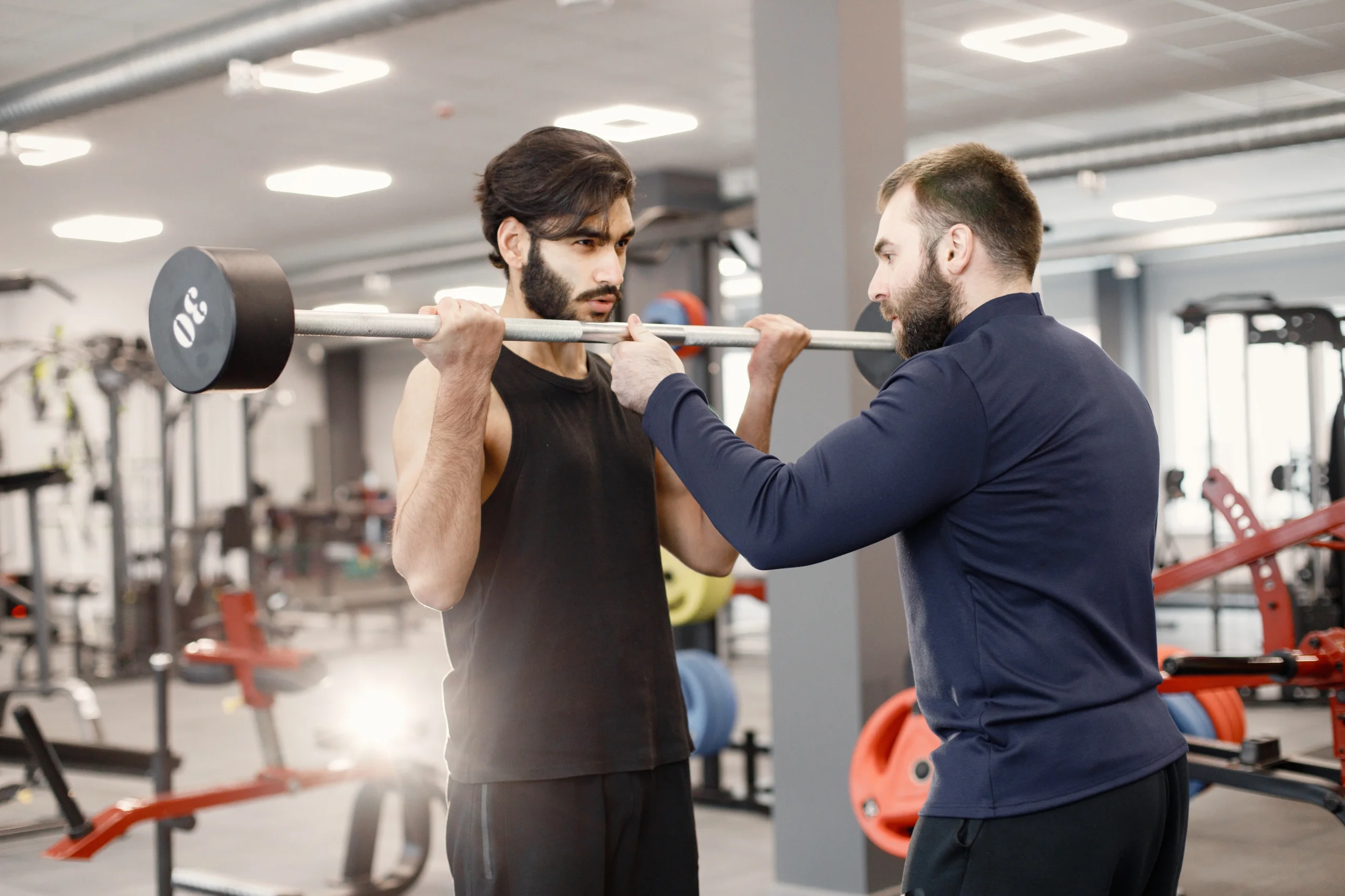 indian man doing excercisses special equipment gym with personal trainer scaled indian man doing excercisses special equipment gym with personal trainer scaled