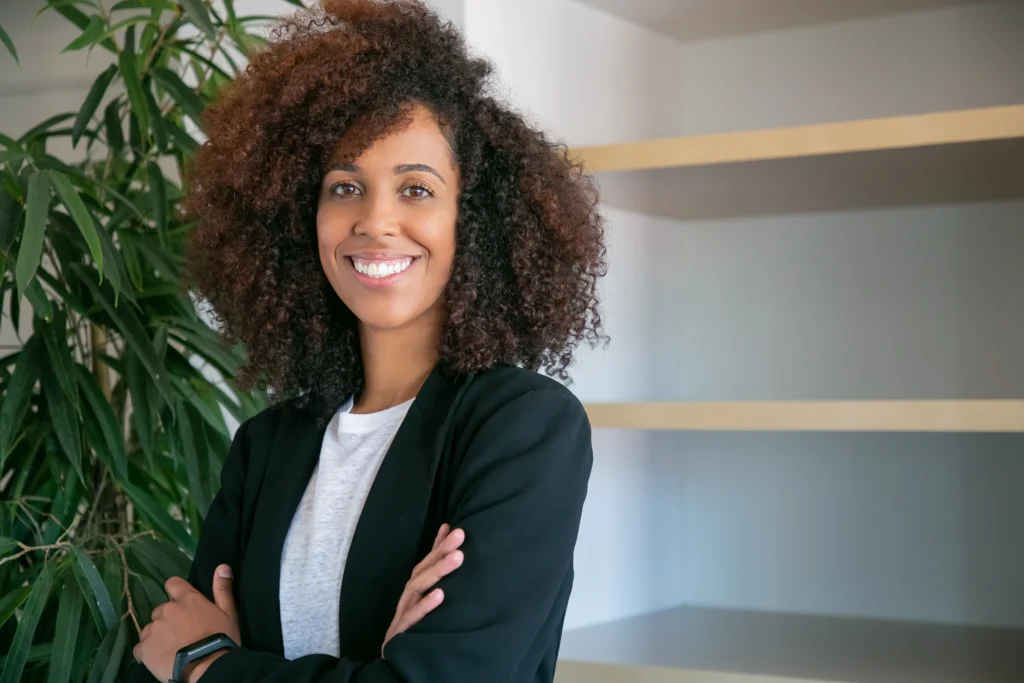 african american curly businesswoman standing with folded hands portrait successful confident young pretty female office employer suit posing work business company management concept african american curly businesswoman standing with folded hands portrait successful confident young pretty female office employer suit posing work business company management concept