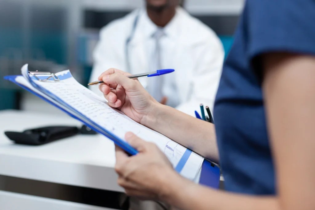 closeup patient mother writing medical information document closeup patient mother writing medical information document