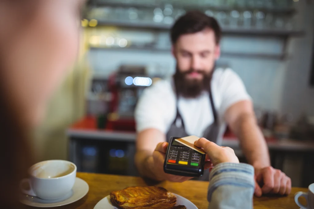 customer making payment through payment terminal counter customer making payment through payment terminal counter
