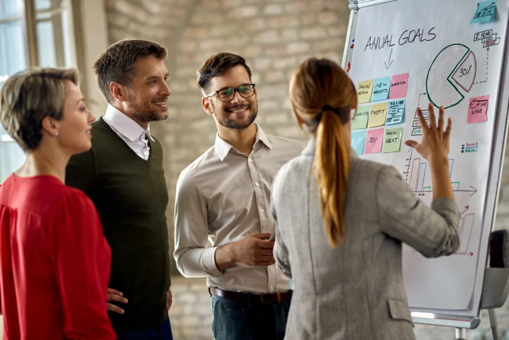 happy business team cooperating while analyzing their business progress whiteboard office happy business team cooperating while analyzing their business progress whiteboard office