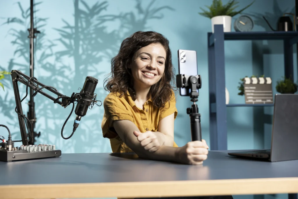 joyous influencer filming vlog with phone studio using professional mic joyous influencer filming vlog with phone studio using professional mic
