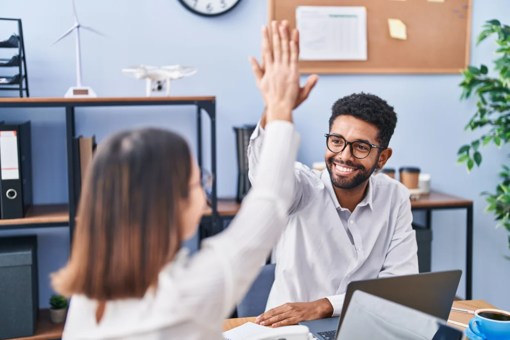 man woman business workers high five with hands raised up office man woman business workers high five with hands raised up office
