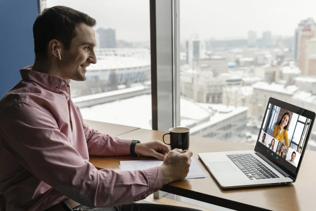 side view man having online video call with coworkers side view man having online video call with coworkers