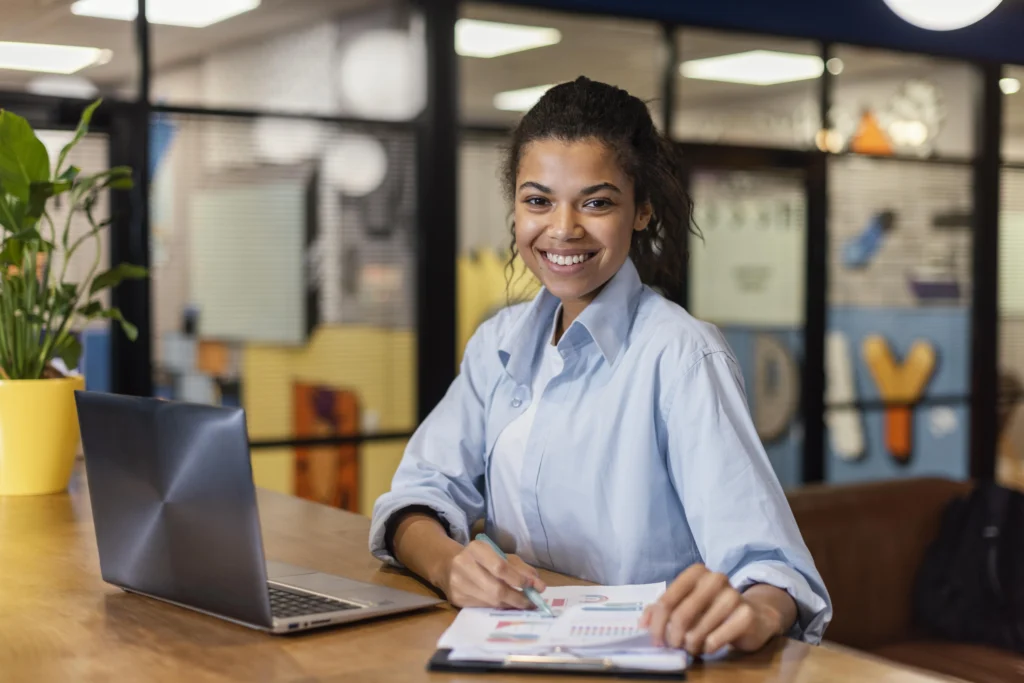 smiley woman working with laptop papers office smiley woman working with laptop papers office