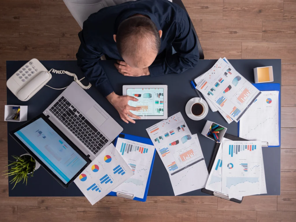 top view businessman using tablet pc analyzing financial charts documents sitting desk corporate office top view businessman using tablet pc analyzing financial charts documents sitting desk corporate office