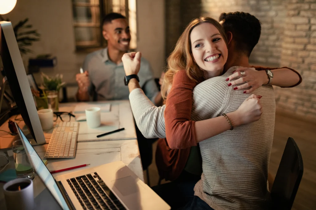 happy businesswoman embracing her coworker while celebrating success office happy businesswoman embracing her coworker while celebrating success office