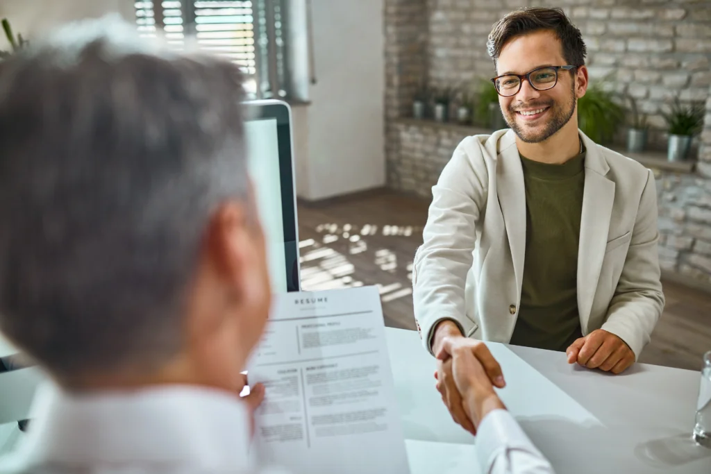 happy male candidate greeting member human resource team job interview office happy male candidate greeting member human resource team job interview office