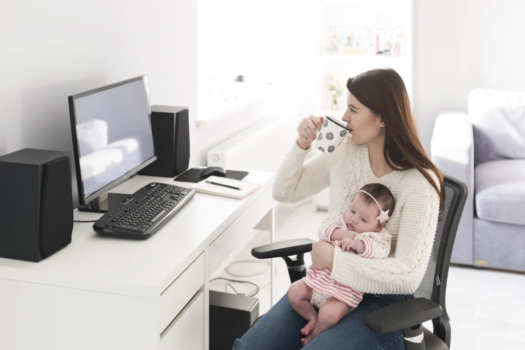 woman with cup holding daughter computer woman with cup holding daughter computer