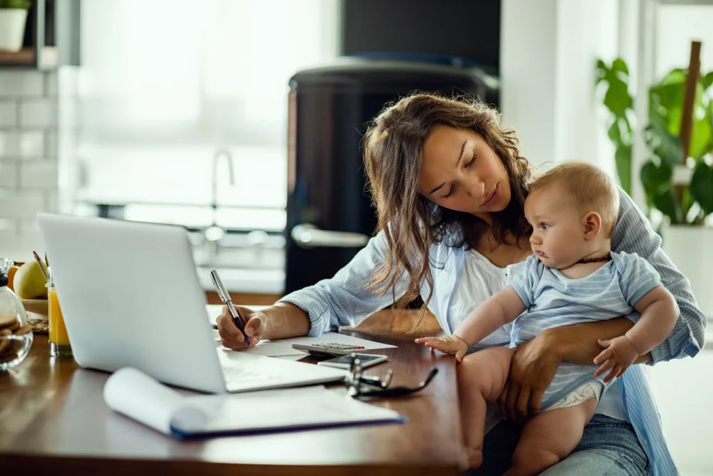 young working mother planning home budget while being with her baby home young working mother planning home budget while being with her baby home